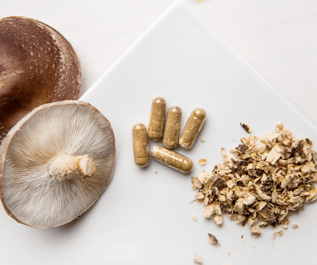 mushroom capsules and powder on a table