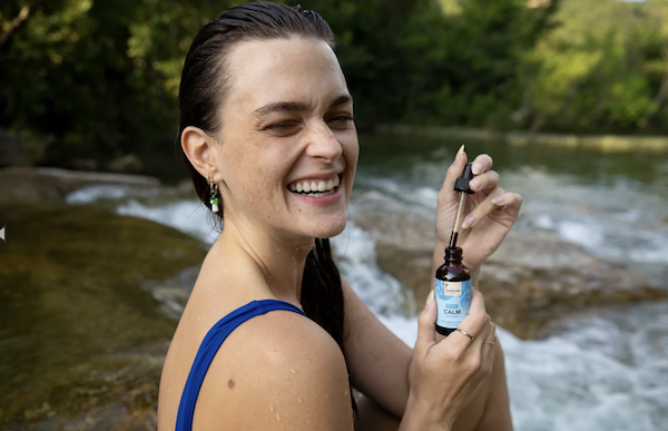 Woman taking reishi calm tincture